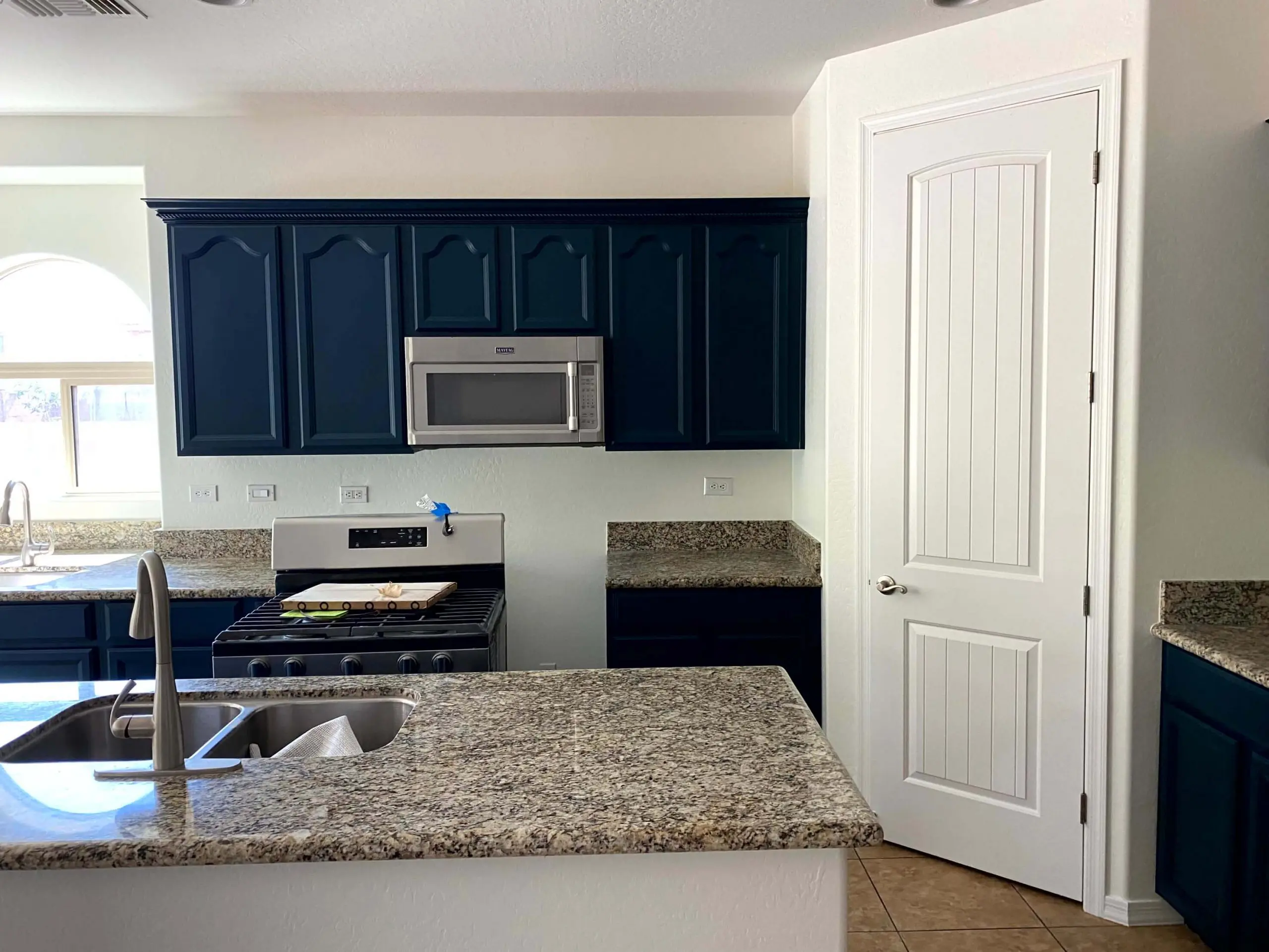 Navy kitchen cabinets professionally painted by Butcher’s Custom Painting in Peoria, AZ