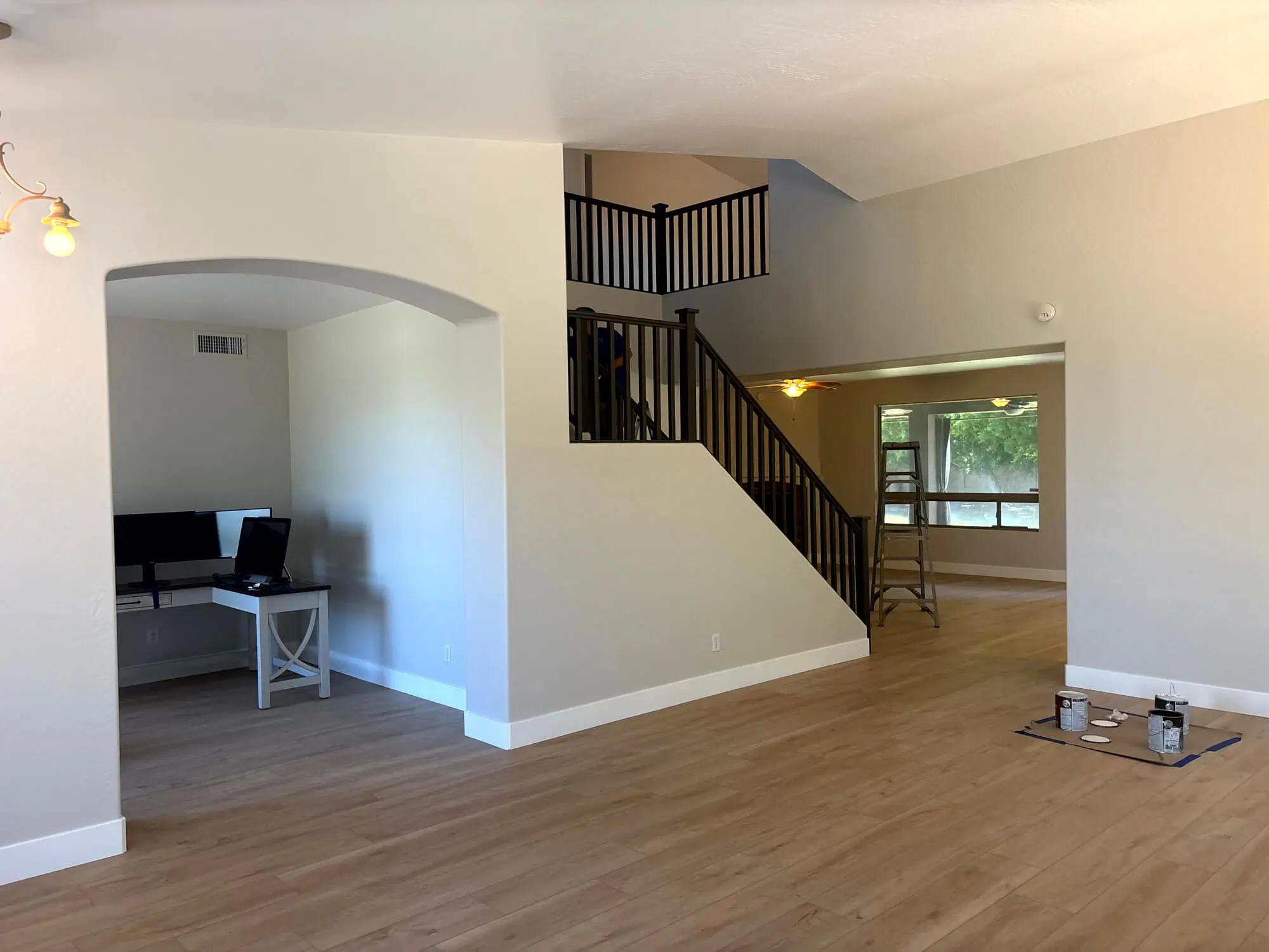 Spacious interior featuring freshly painted neutral walls, crisp white baseboards, and dark wood railings professionally completed by Butchers Custom Painting.