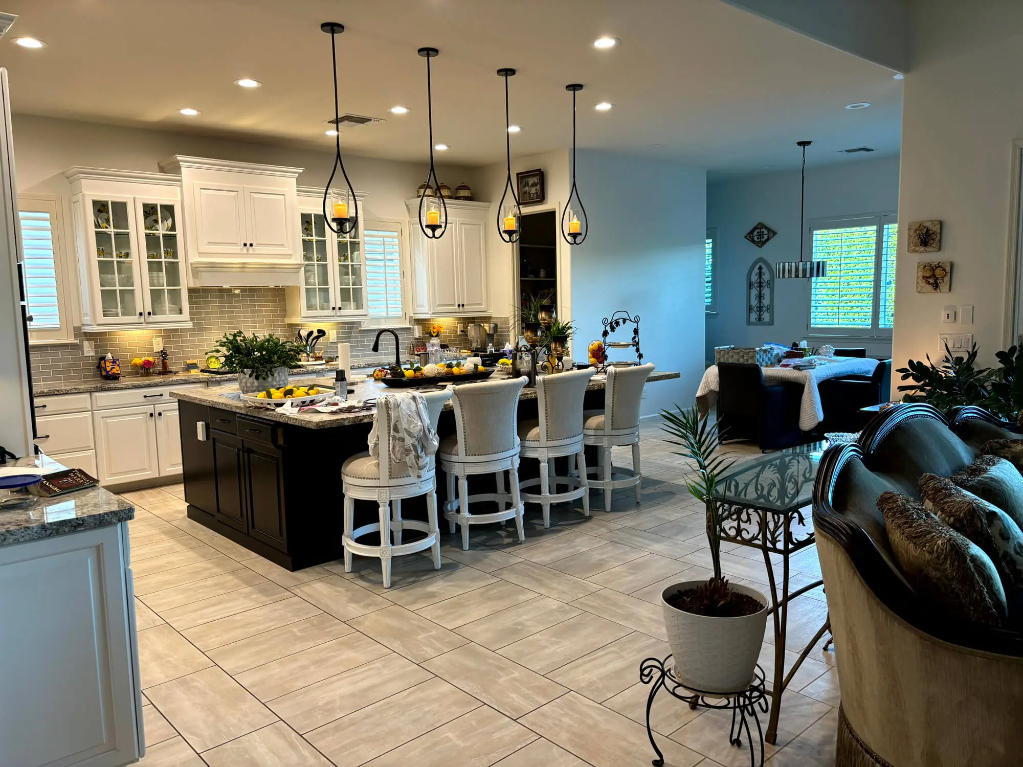 Elegant kitchen remodel featuring custom-painted white cabinetry and a dark wood island expertly finished by Butchers Custom Painting.