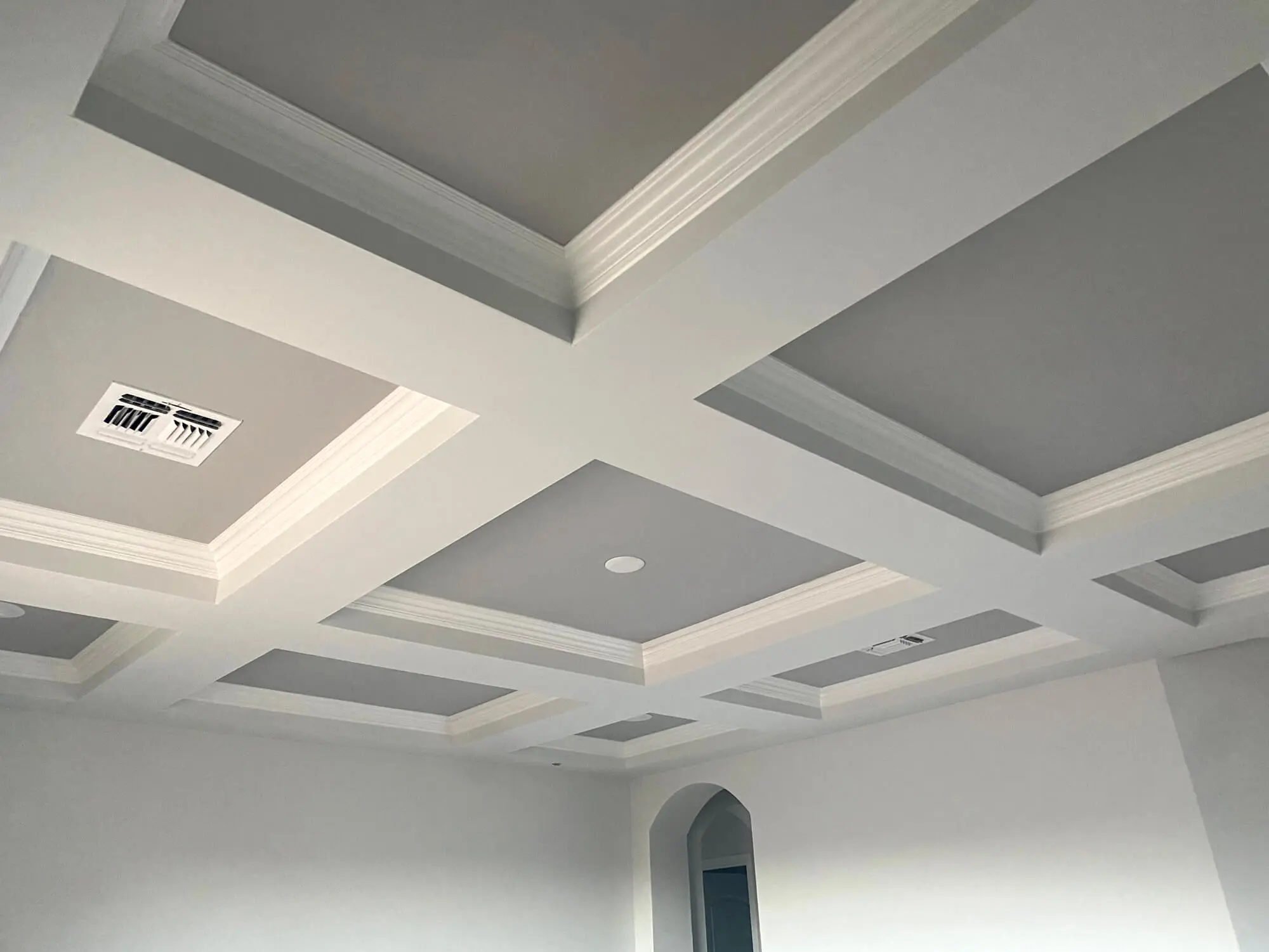 Elegant white coffered ceiling with contrasting gray inset panels and decorative crown molding, expertly finished by Butchers Custom Painting.