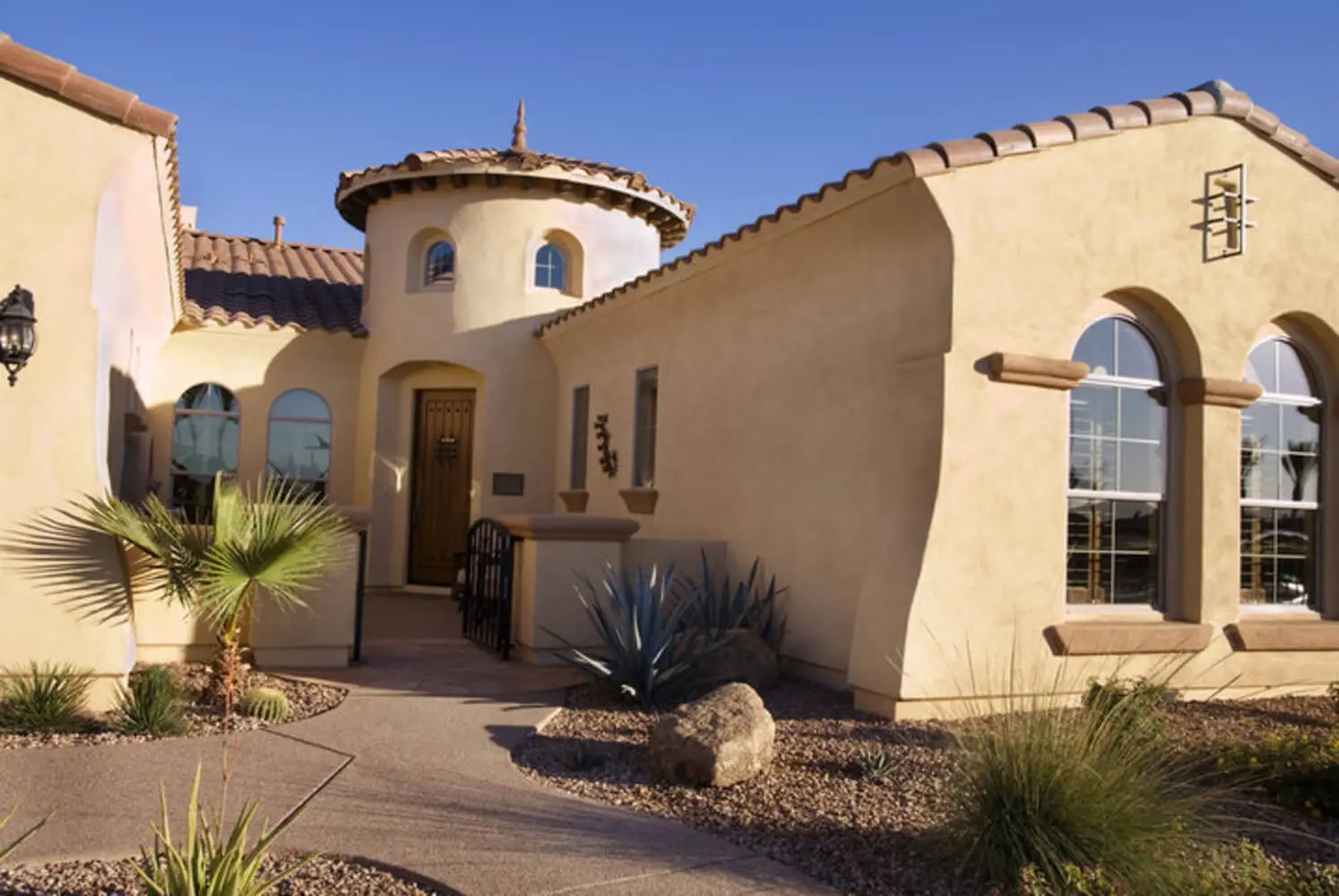 A Spanish-style stucco home exterior in Peoria, Arizona showing the type of surface elastomeric coating is designed to protect.