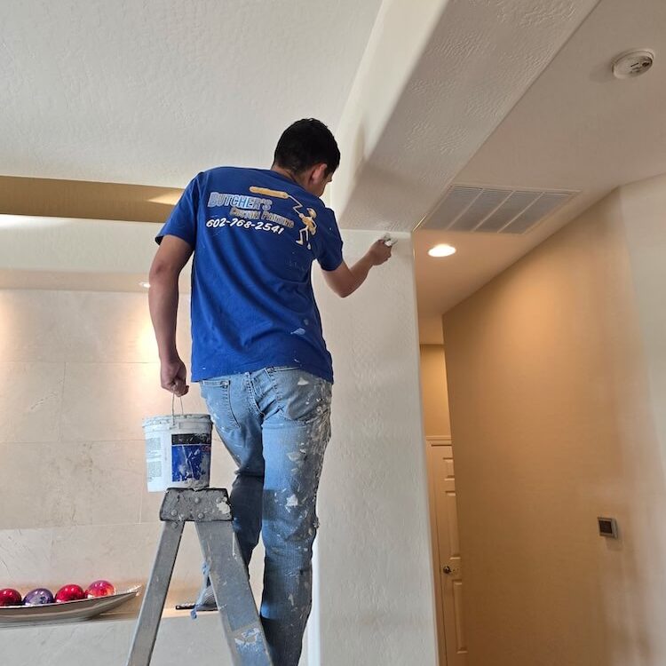 butcher's custom painting team member painting home interior in peoria az